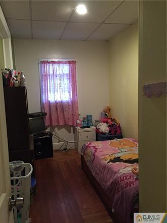 333 New Market Road Dunellen, NJ 08812 - Photo 5 of 19 a bedroom with a bed and a window