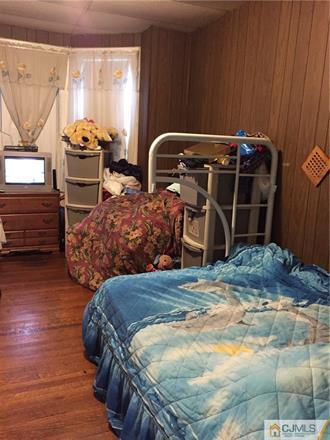 333 New Market Road Dunellen, NJ 08812 - Photo 6 of 19 a bedroom with bed and a window