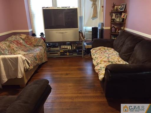 333 New Market Road Dunellen, NJ 08812 - Photo 8 of 19 a living room with furniture and a flat screen tv
