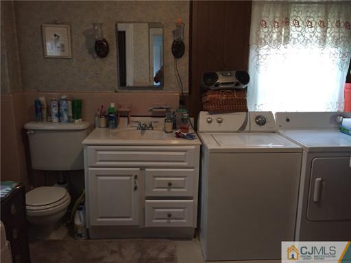 333 New Market Road Dunellen, NJ 08812 - Photo 9 of 19 a bathroom with a granite countertop sink toilet and mirror