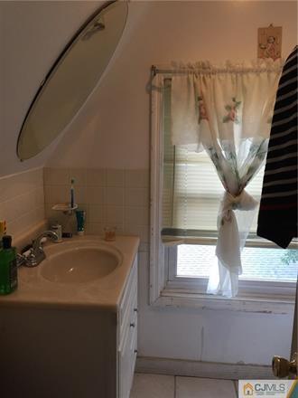 333 New Market Road Dunellen, NJ 08812 - Photo 10 of 19 a bathroom with a sink and a mirror