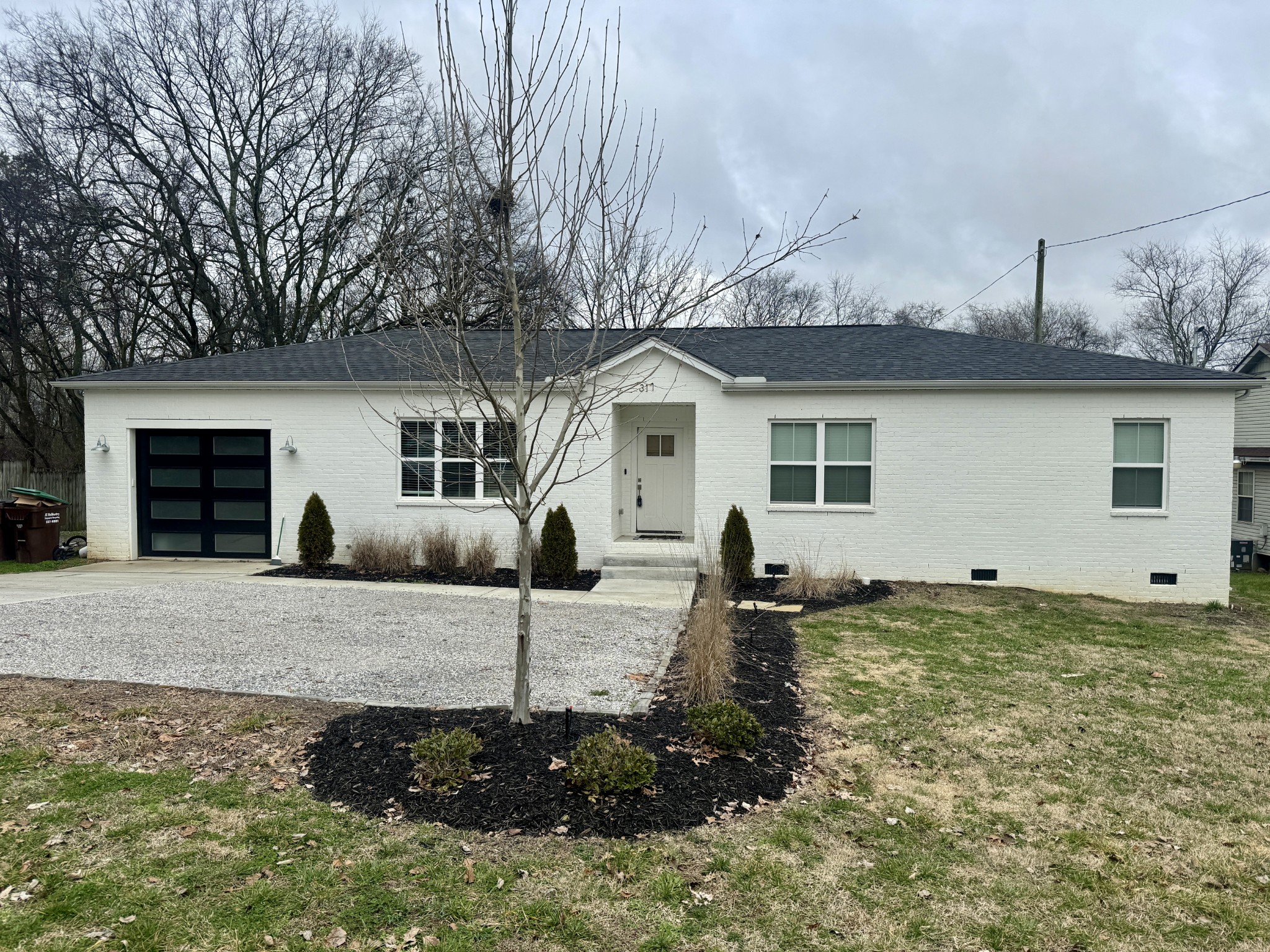 a view of a house with backyard and trees