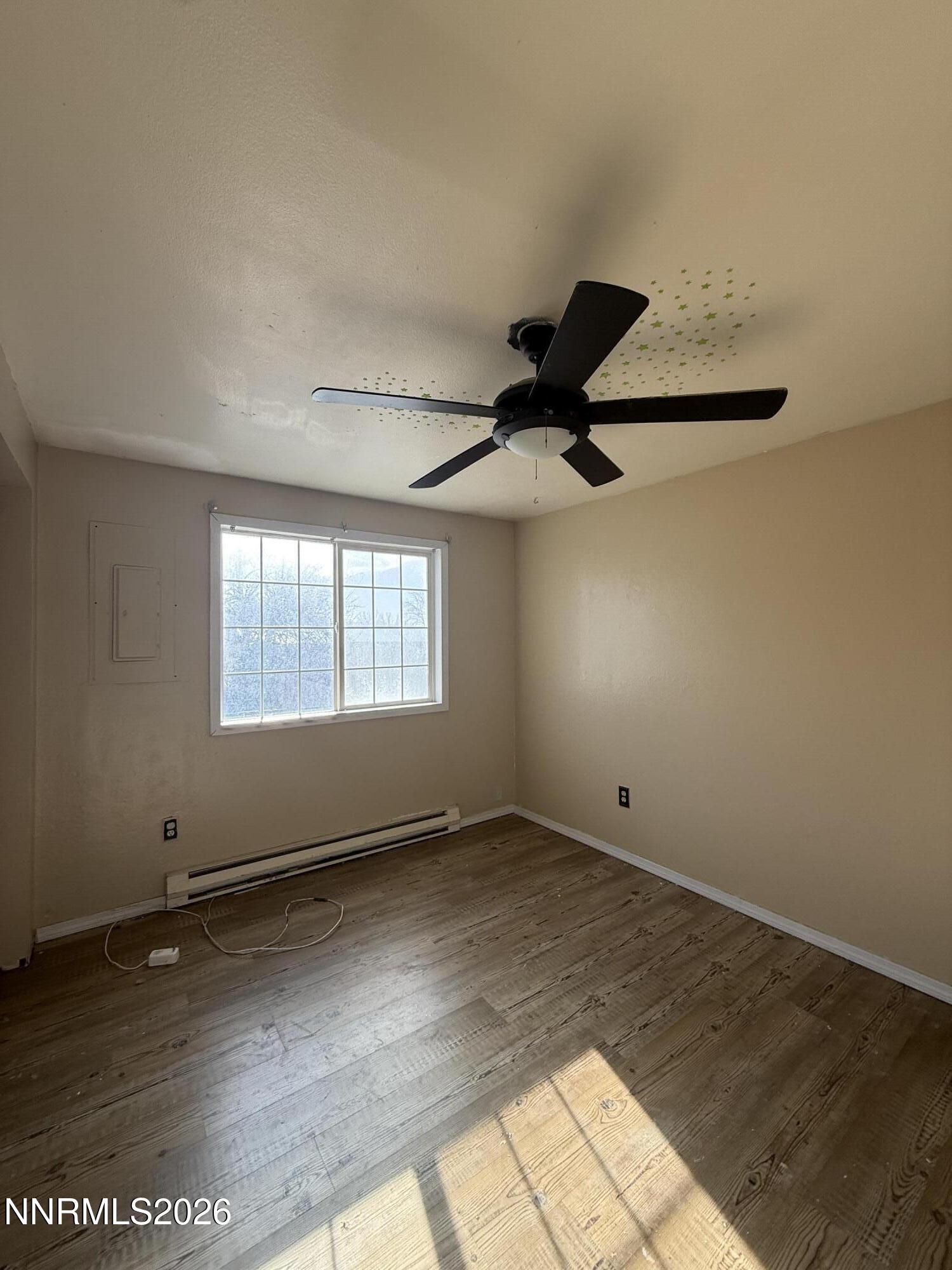 1362 Kodac Street Winnemucca, NV 89445 - Photo 11 of 21 an empty room with wooden floor and windows