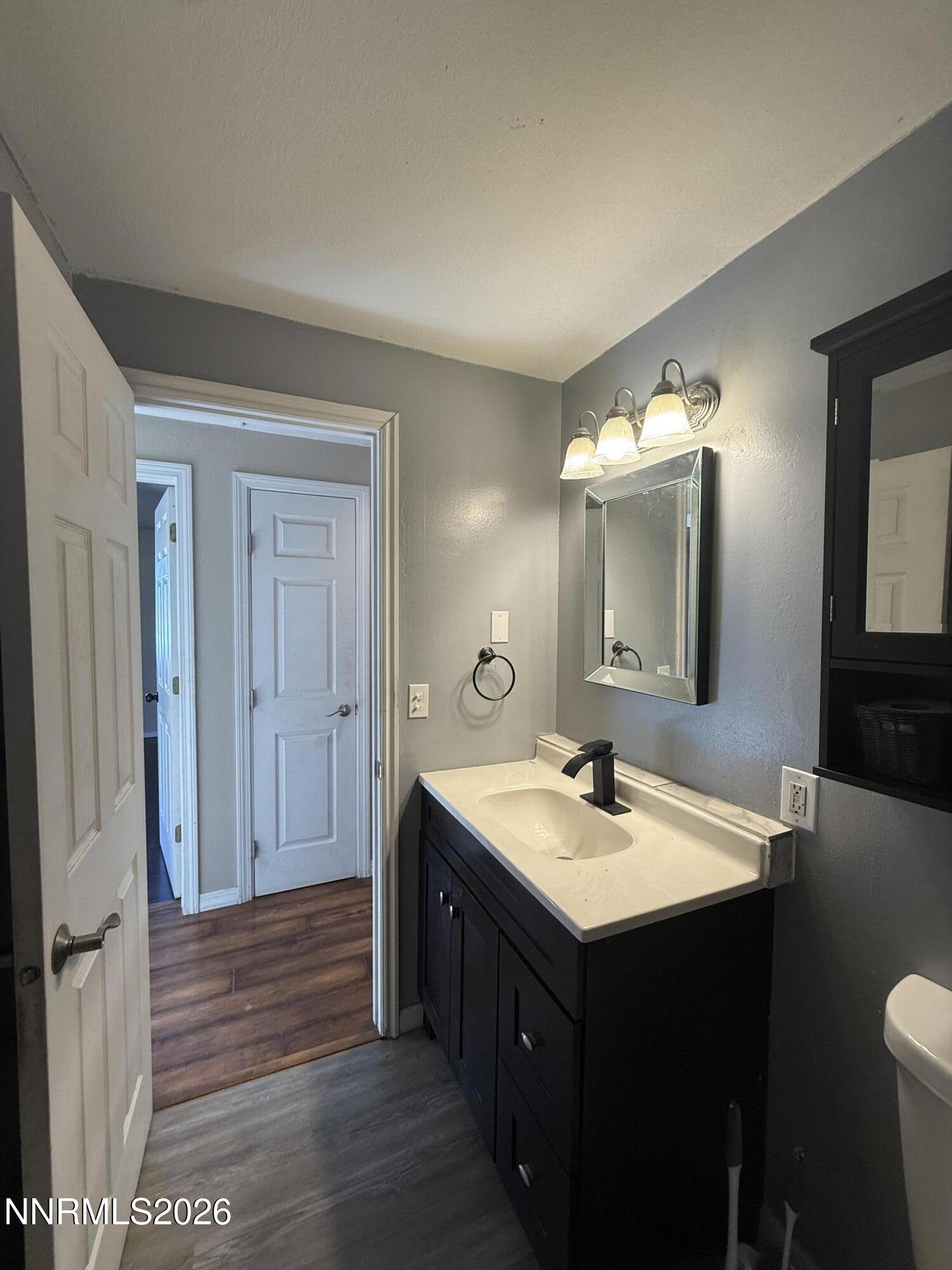 1362 Kodac Street Winnemucca, NV 89445 - Photo 17 of 21 a bathroom with a sink vanity and a mirror