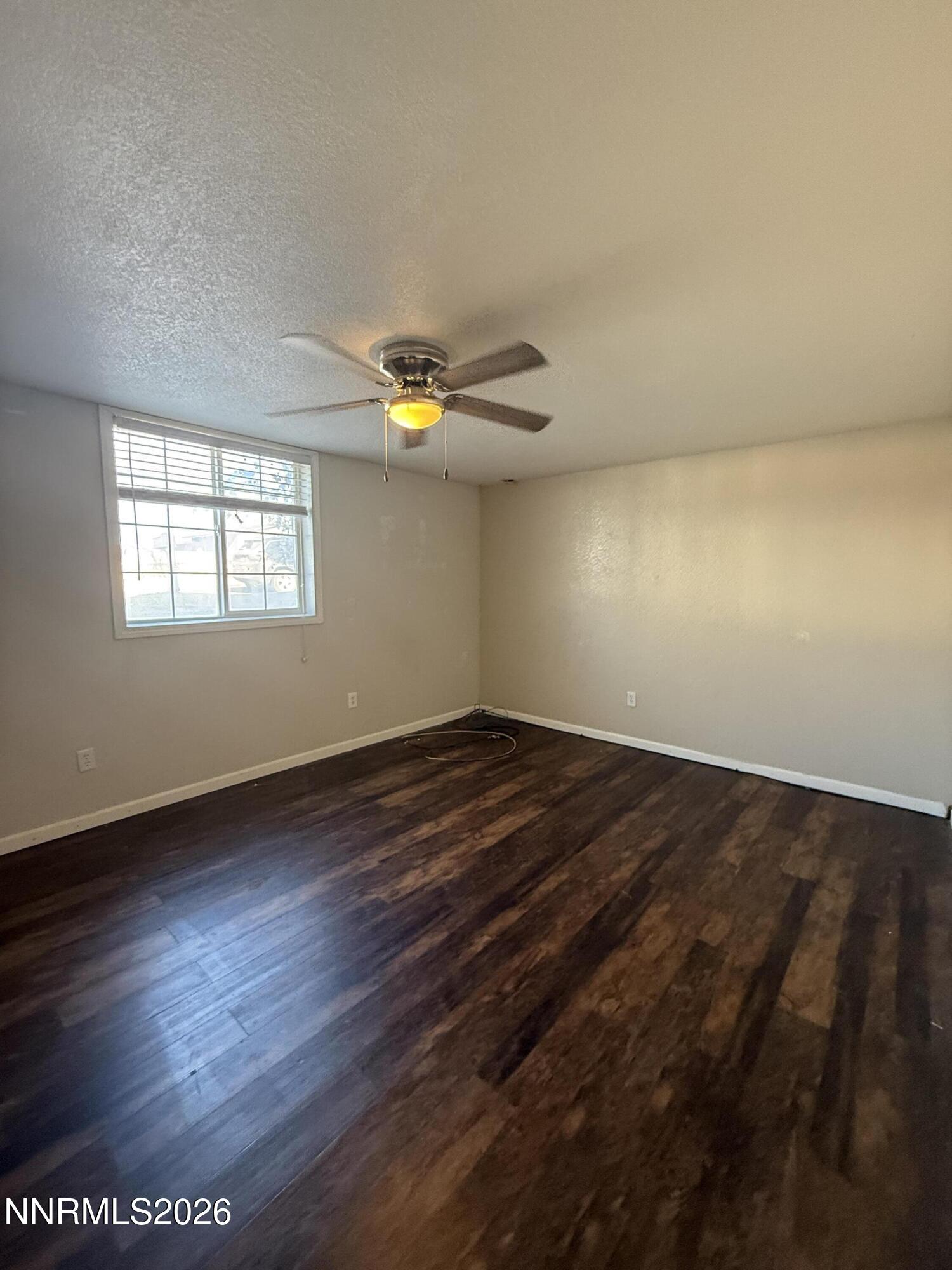 1362 Kodac Street Winnemucca, NV 89445 - Photo 20 of 21 an empty room with wooden floor and windows