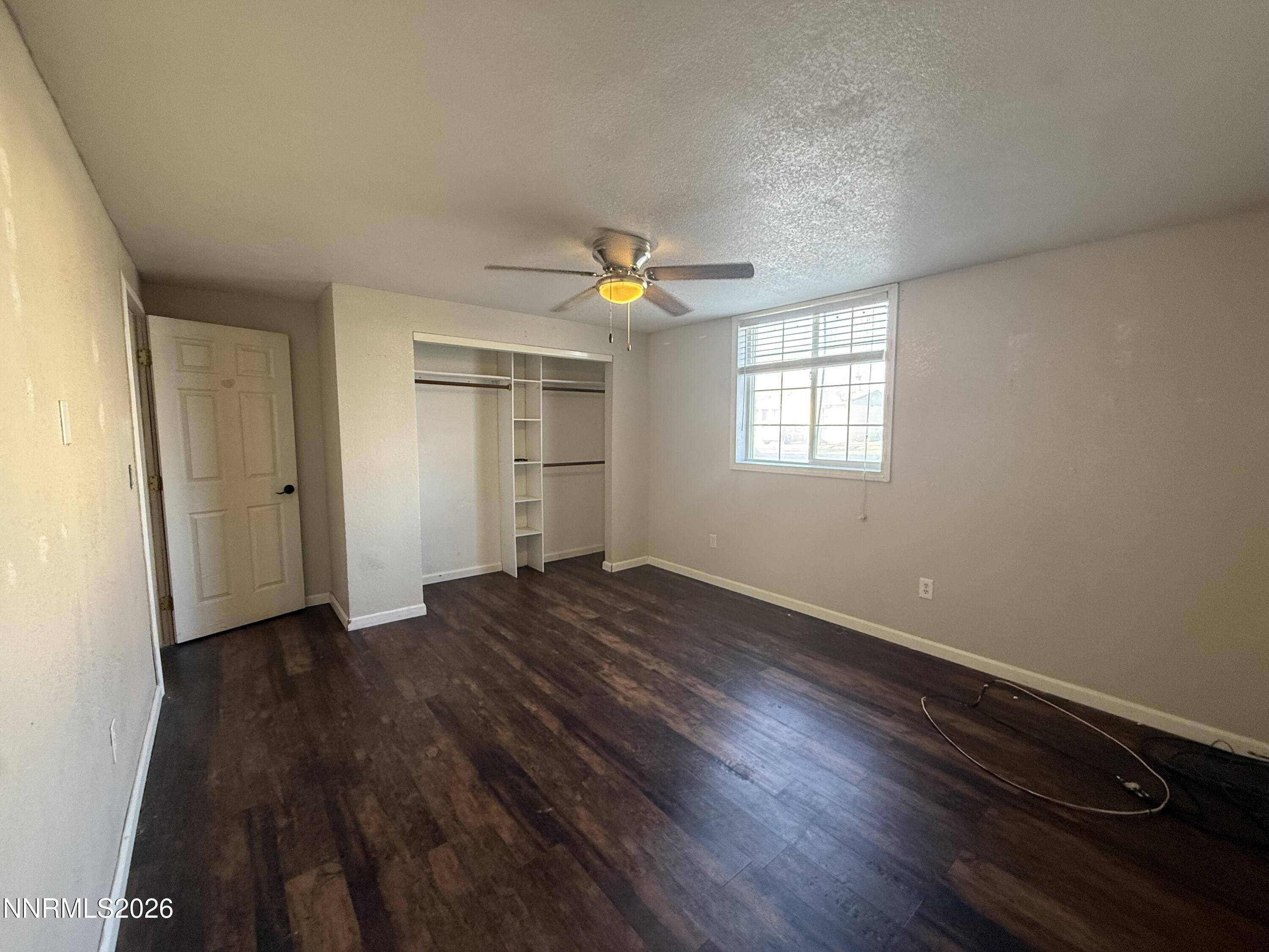 1362 Kodac Street Winnemucca, NV 89445 - Photo 21 of 21 an empty room with wooden floor and window