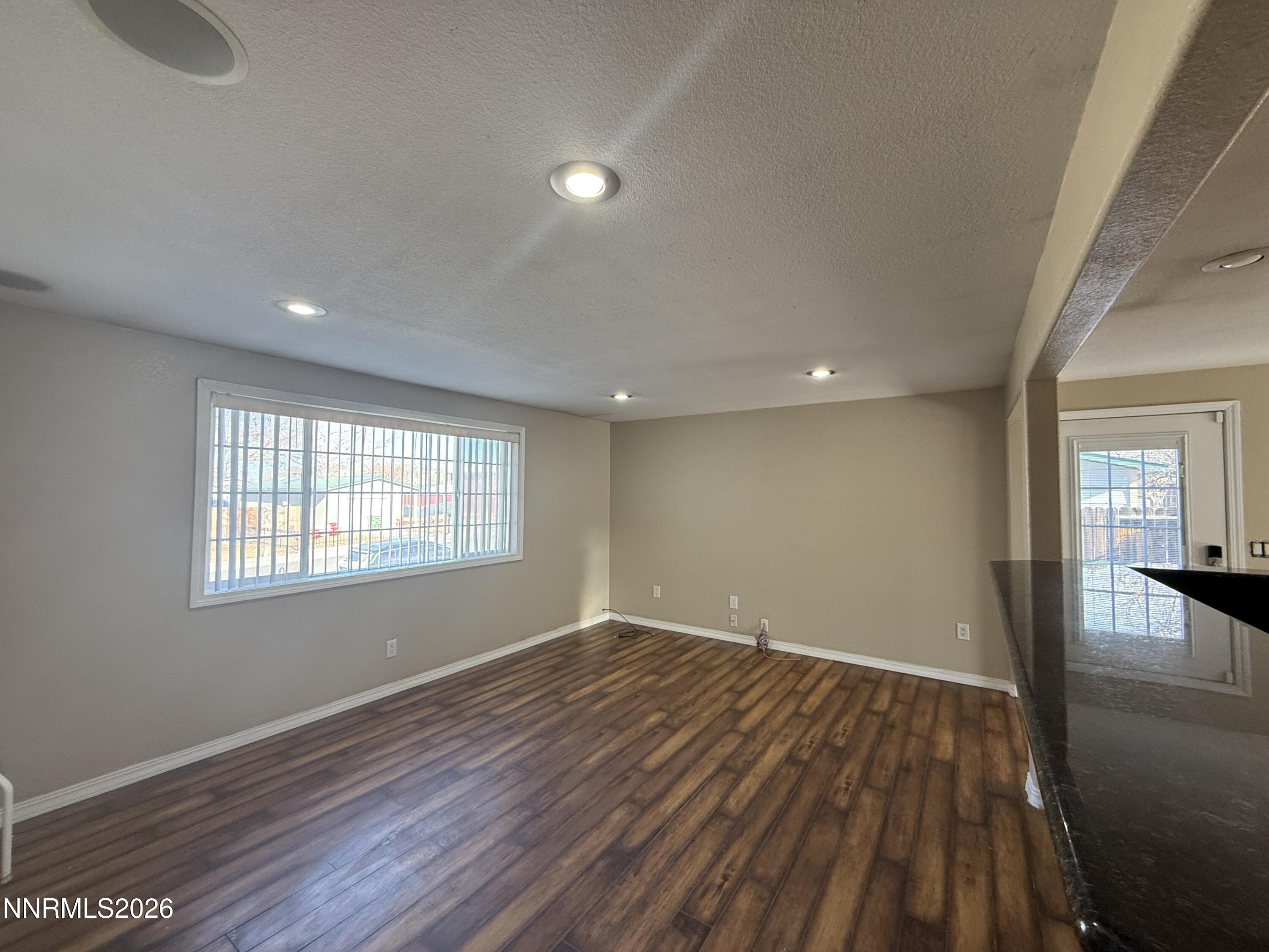 1362 Kodac Street Winnemucca, NV 89445 - Photo 4 of 21 a view of empty room with wooden floor and fan
