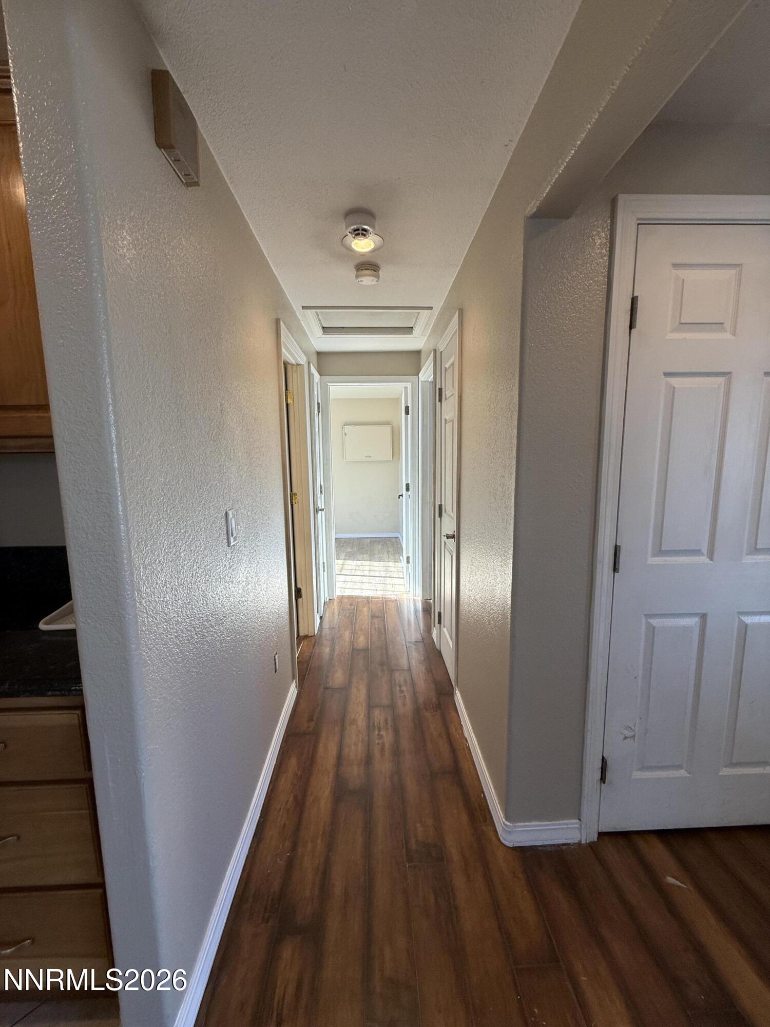 1362 Kodac Street Winnemucca, NV 89445 - Photo 9 of 21 a view of a hallway with wooden floor