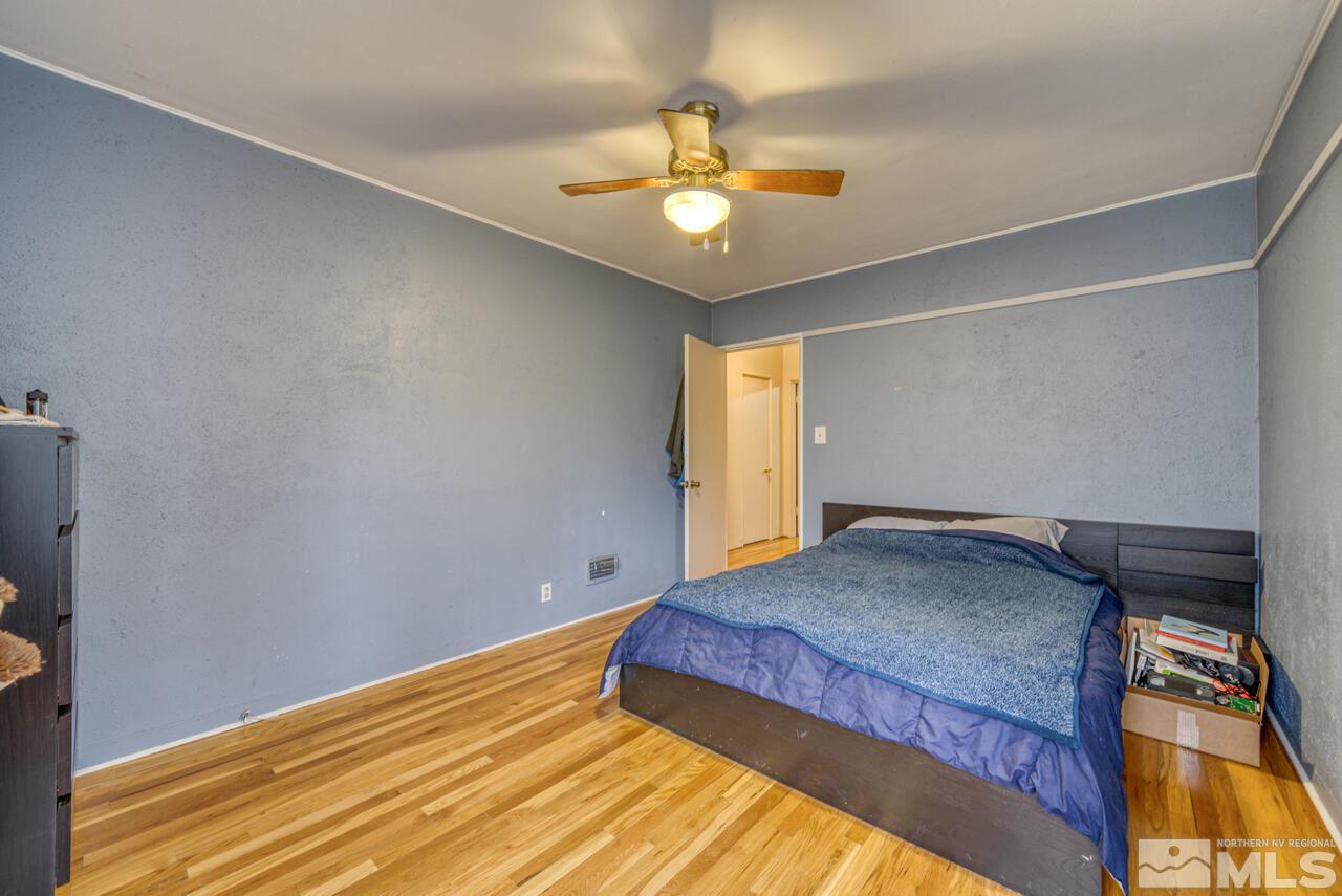 701 West Pueblo Street Reno, NV 89509 - Photo 20 of 30 a bedroom with a bed and a chandelier