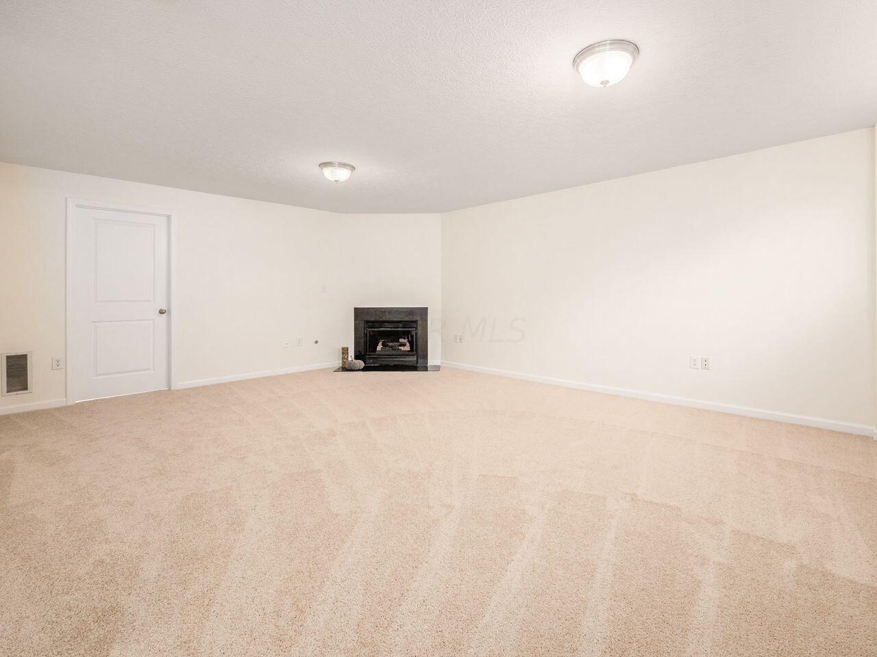 6305 Needletail Road, Unit 25 Columbus, OH 43230 - Photo 28 of 49 The lower level features new carpet and a gas log-burning fireplace.