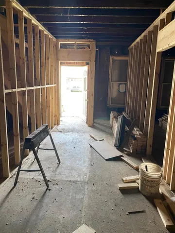 a view of water heater room with wooden floor