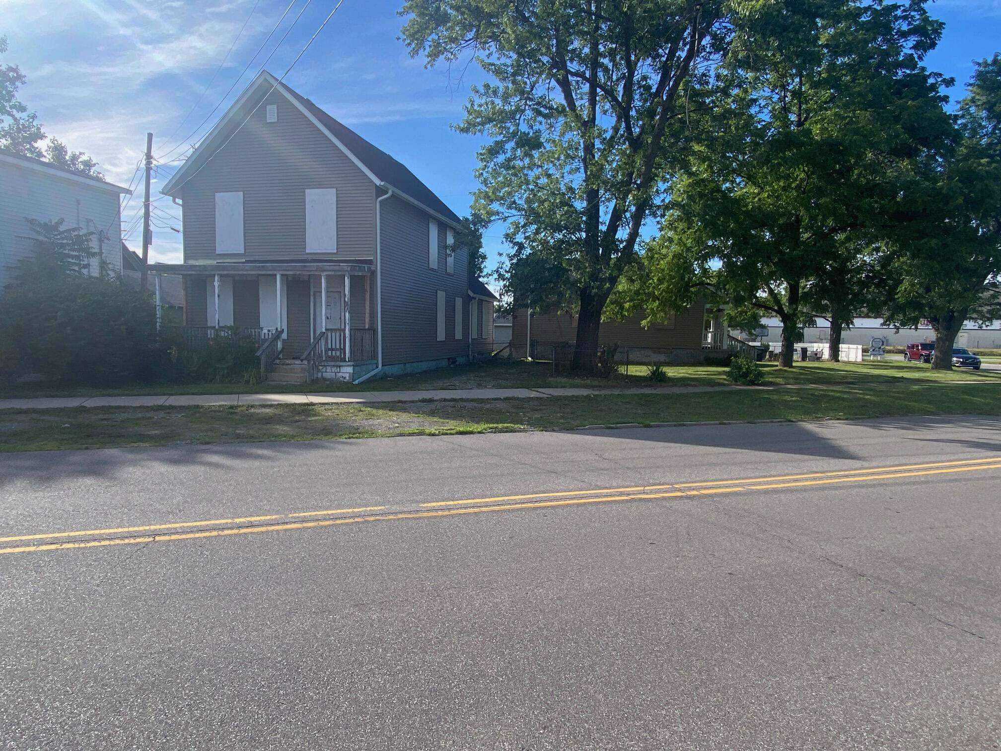 207 Chicago Street Michigan City, IN 46360 - Photo 6 of 14 a view of a house with a yard and large trees
