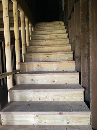 a view of a porch with furniture and a gate
