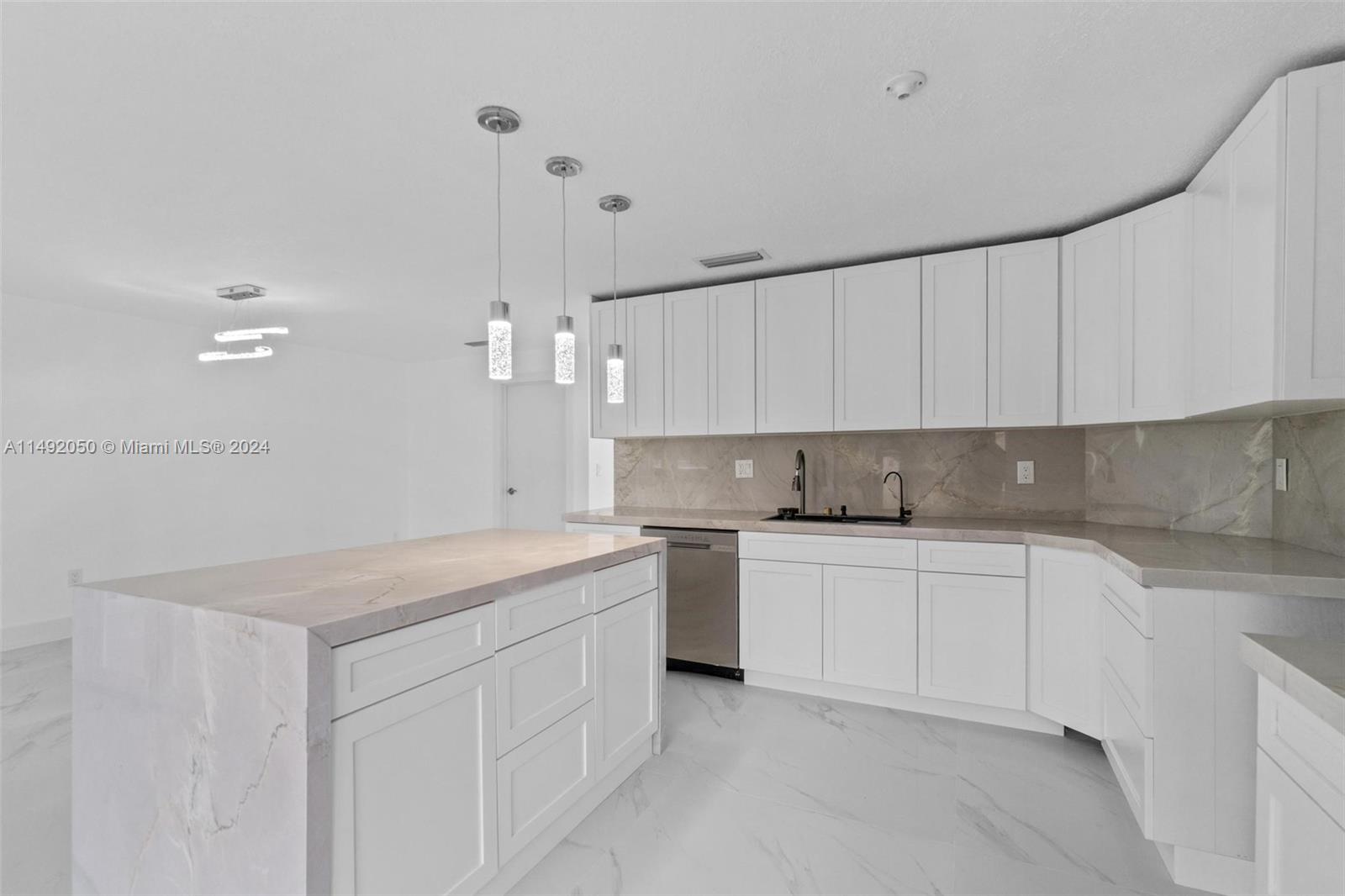 15951 Southwest 42nd Terrace Miami, FL 33185 - Photo 1 of 40 a kitchen that has a lot of cabinets in it with granite countertop stainless steel appliances