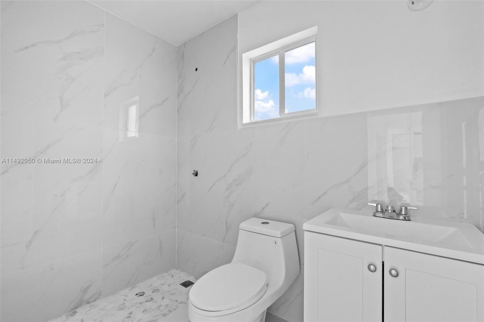 15951 Southwest 42nd Terrace Miami, FL 33185 - Photo 15 of 40 a white toilet sitting next to a bathroom sink