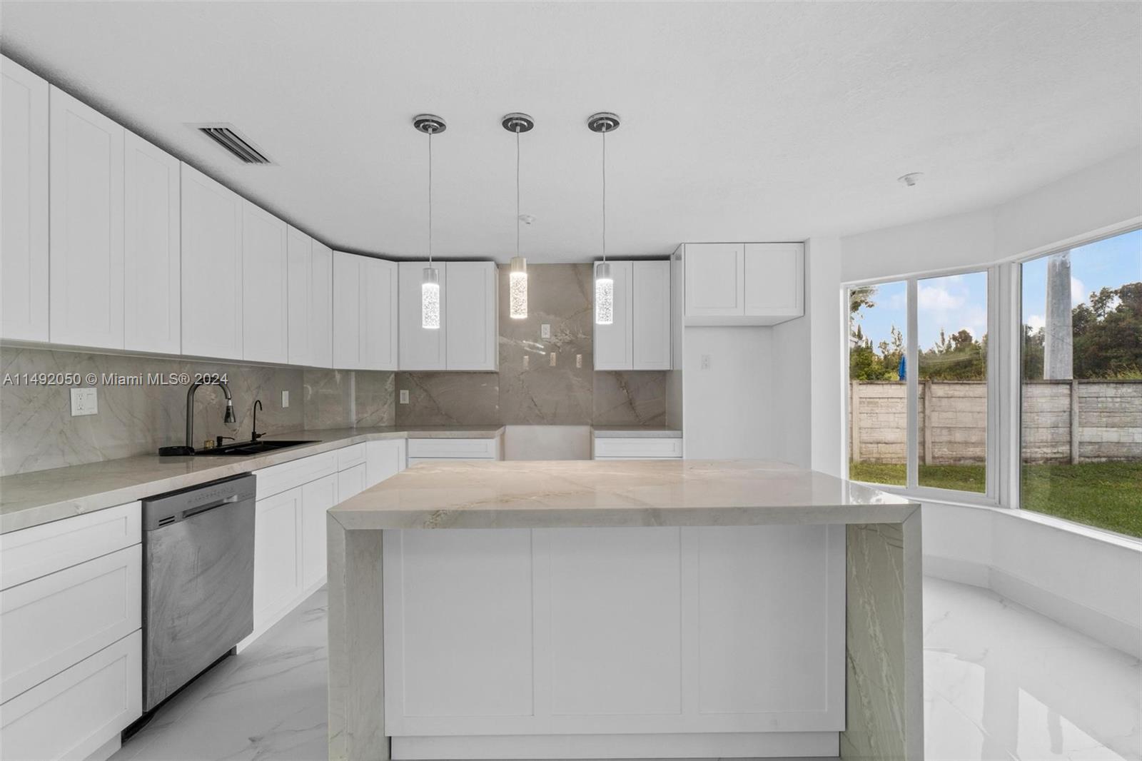 15951 Southwest 42nd Terrace Miami, FL 33185 - Photo 2 of 40 a kitchen with stainless steel appliances granite countertop a sink a stove and a refrigerator