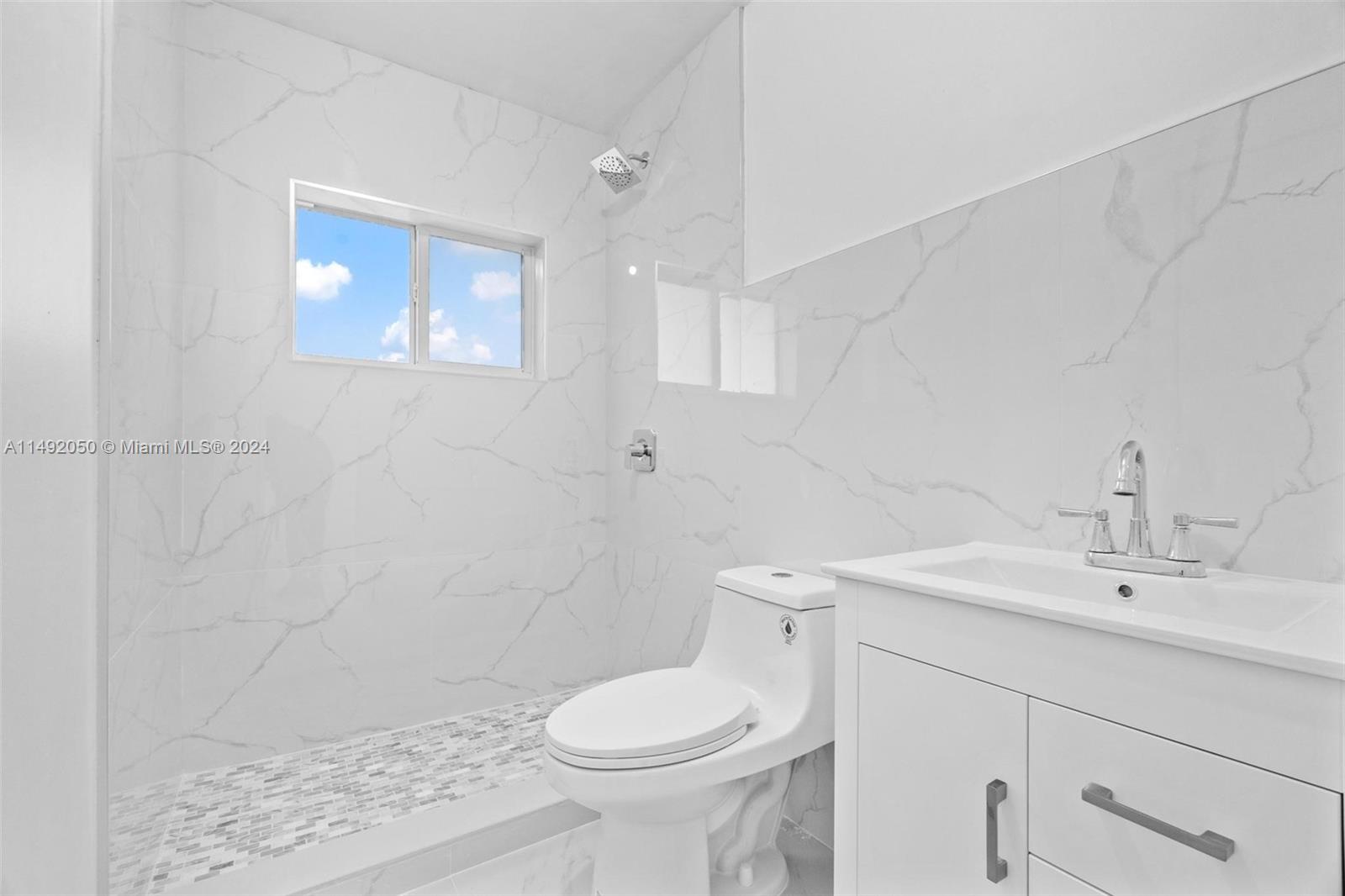 15951 Southwest 42nd Terrace Miami, FL 33185 - Photo 21 of 40 a bathroom with a sink toilet and a mirror