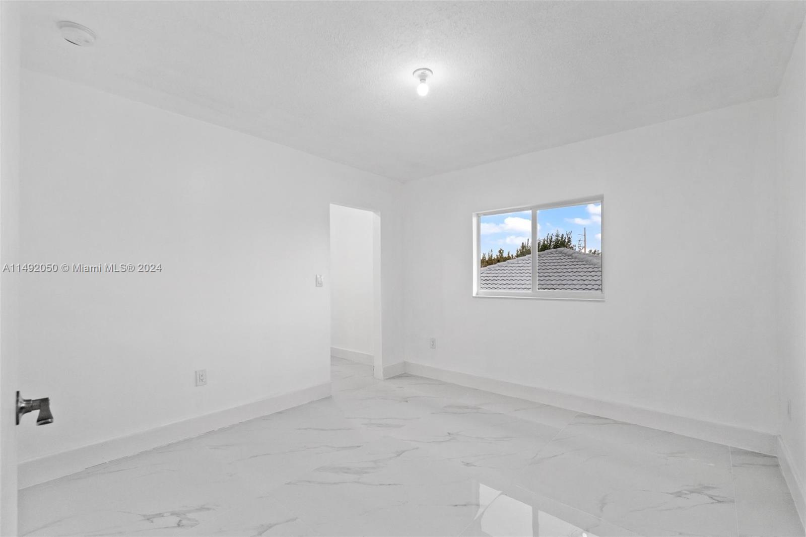 15951 Southwest 42nd Terrace Miami, FL 33185 - Photo 22 of 40 an empty room with windows