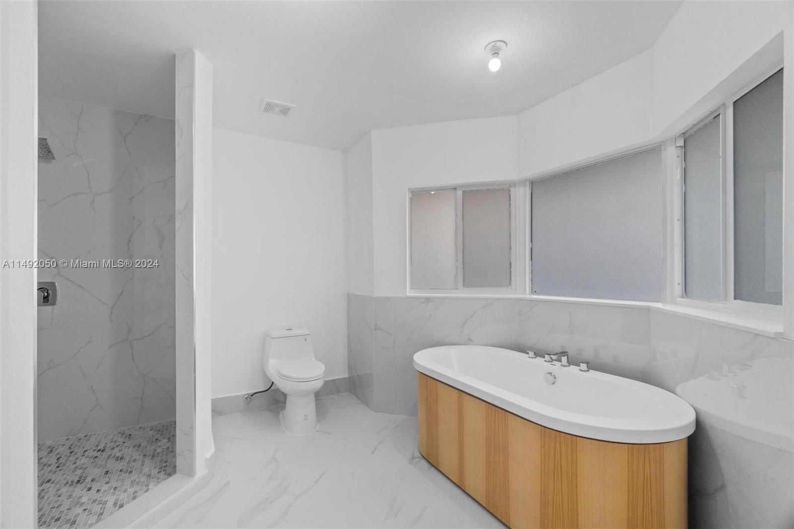 15951 Southwest 42nd Terrace Miami, FL 33185 - Photo 28 of 40 a bathroom with a sink a toilet and shower