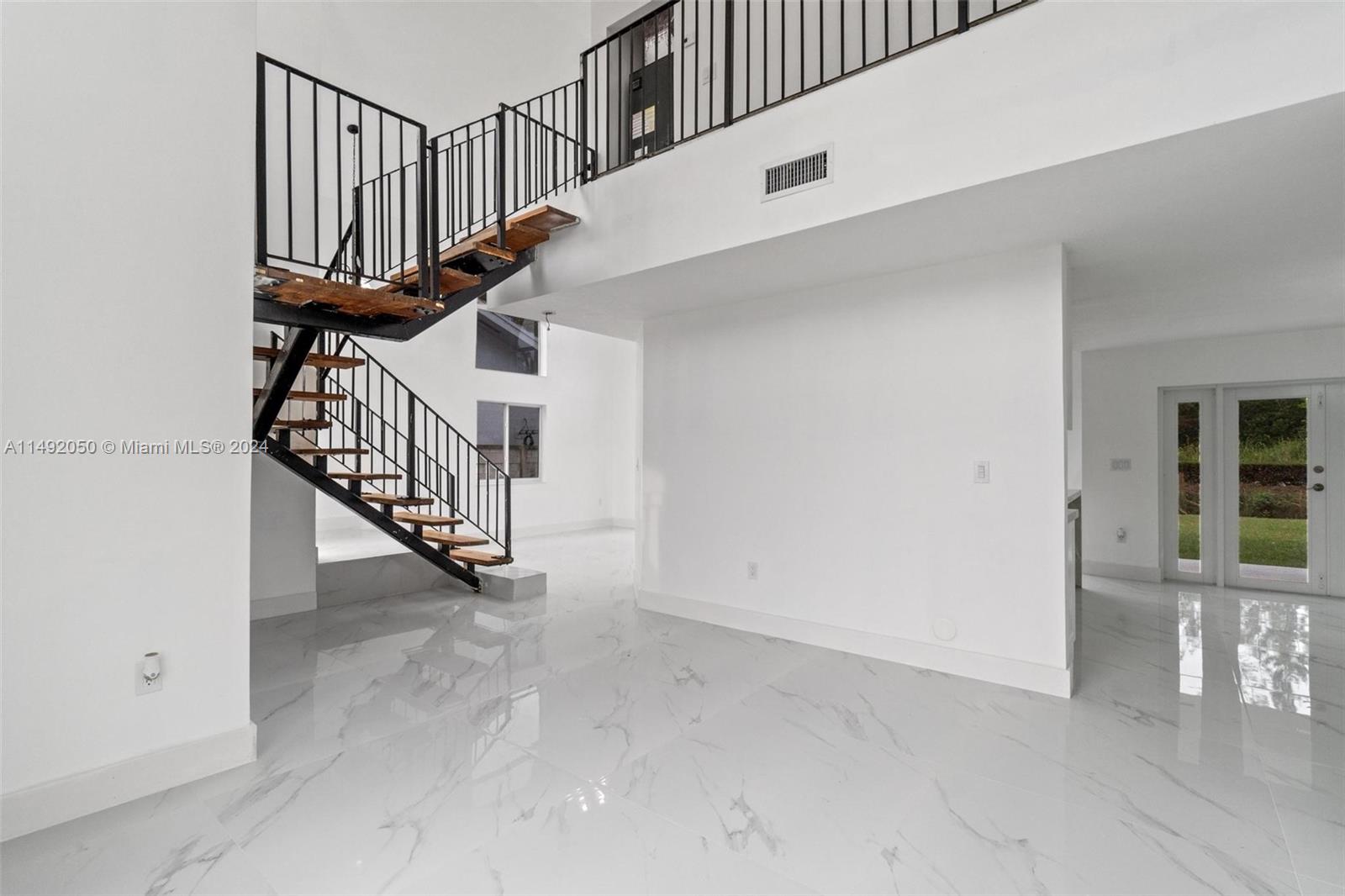 15951 Southwest 42nd Terrace Miami, FL 33185 - Photo 7 of 40 a view of entryway with wooden floor