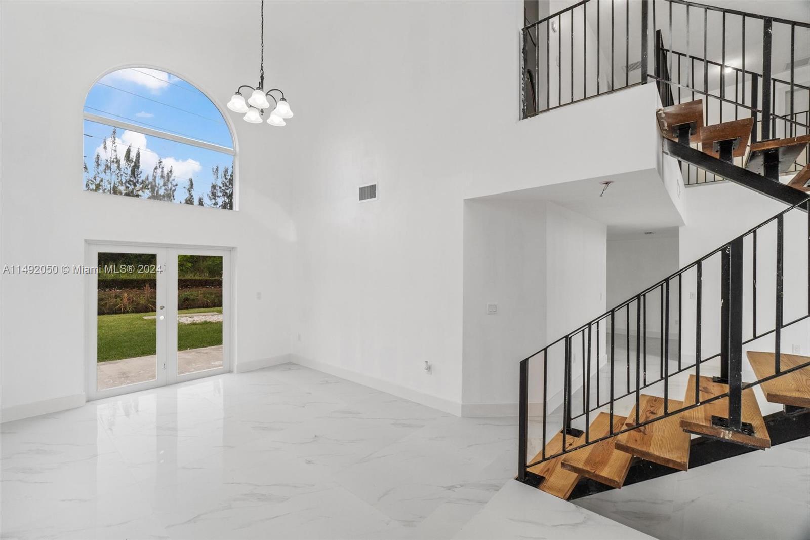 15951 Southwest 42nd Terrace Miami, FL 33185 - Photo 9 of 40 a view of an entryway with wooden floor
