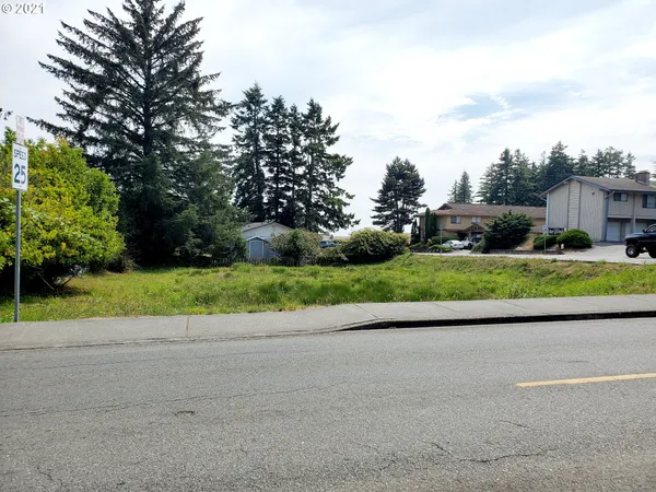 a view of a road with a house in the background