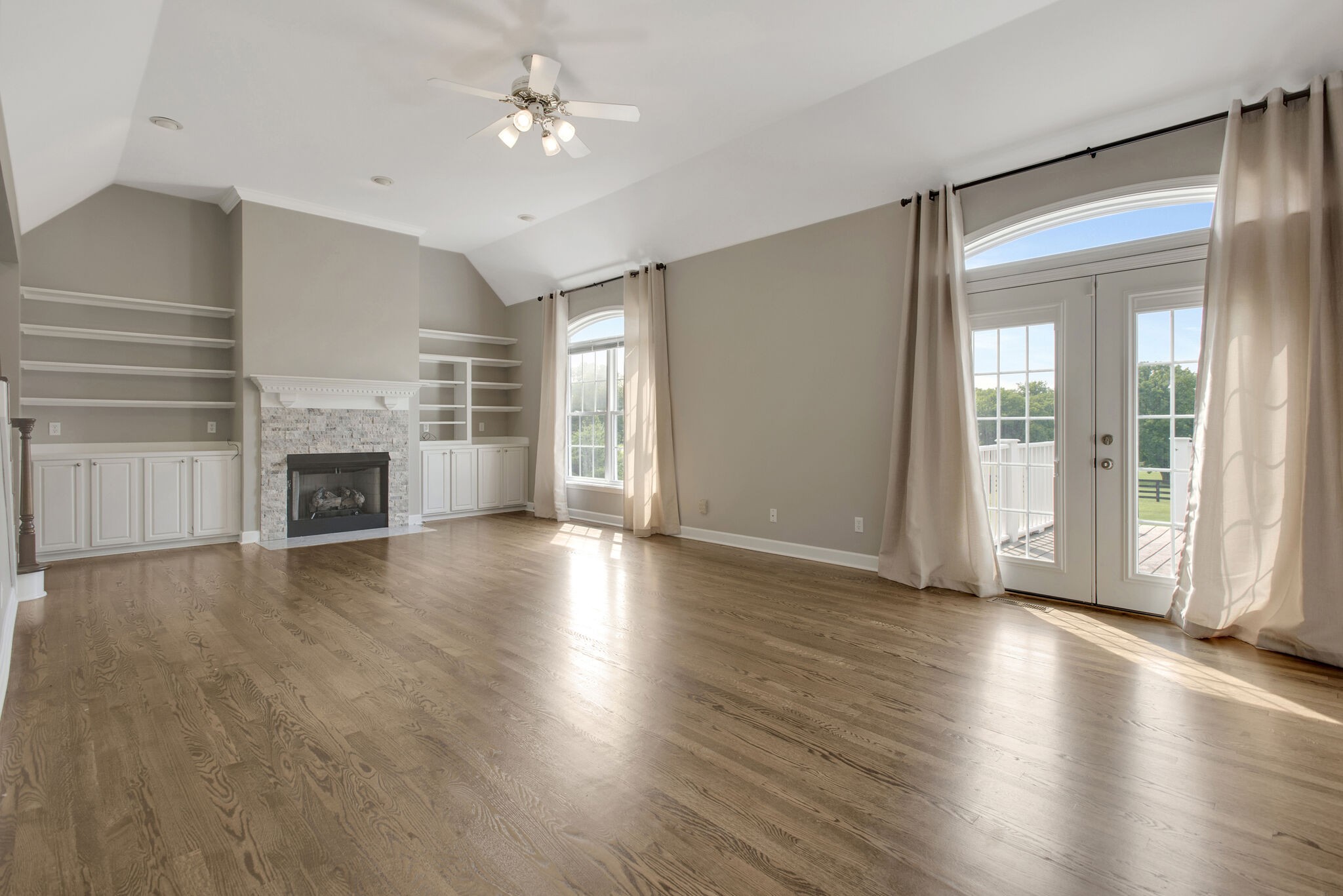 1576 Old Hillsboro Road Franklin, TN 37069 - Photo 11 of 66 an empty room with wooden floor fireplace and windows