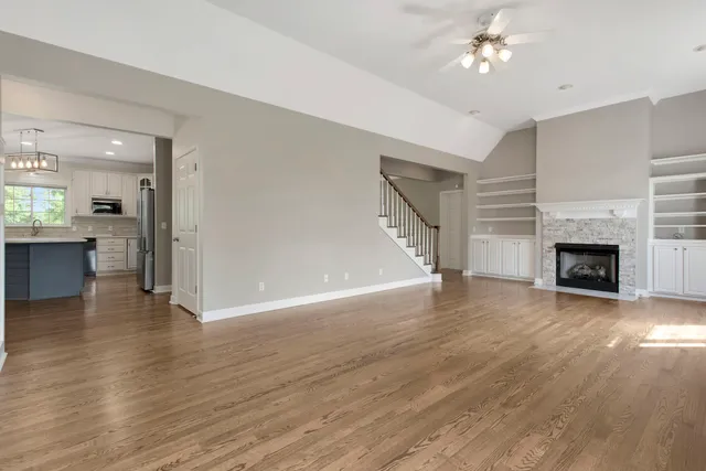 a large kitchen with granite countertop a large counter top space appliances and cabinets