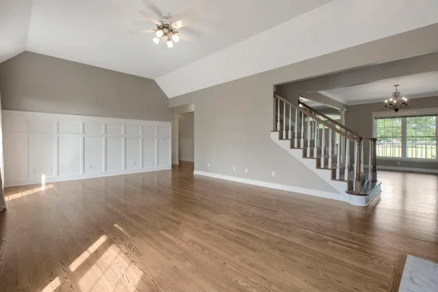 a kitchen with kitchen island granite countertop wooden floors and stainless steel appliances