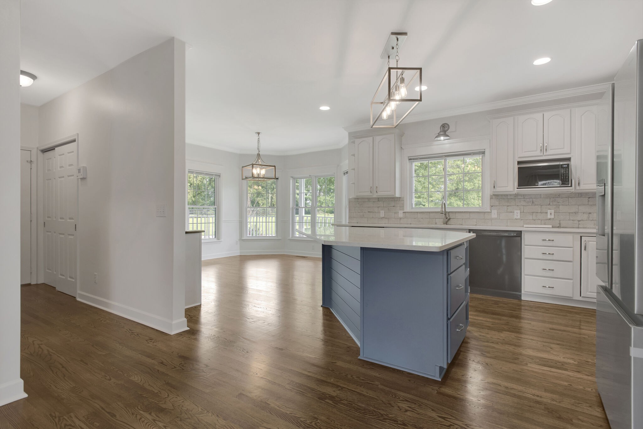 1576 Old Hillsboro Road Franklin, TN 37069 - Photo 16 of 66 a kitchen with kitchen island granite countertop wooden floors and stainless steel appliances