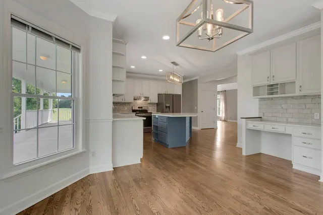 an empty room with a window and a ceiling fan