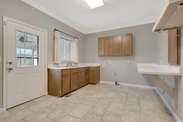 an empty room with ceiling fan and window
