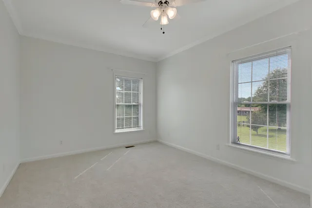 a room with pool table and windows