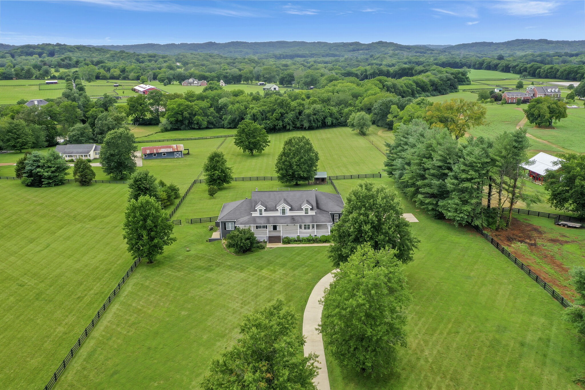 1576 Old Hillsboro Road Franklin, TN 37069 - Photo 65 of 66 an aerial view of green landscape with trees houses in the background