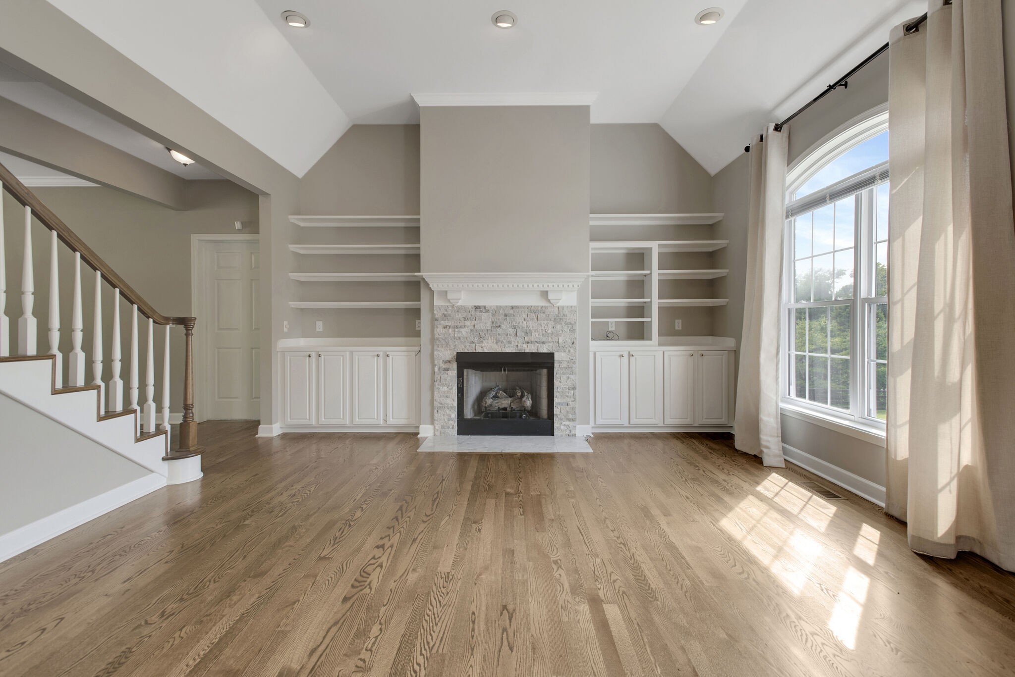 1576 Old Hillsboro Road Franklin, TN 37069 - Photo 10 of 66 a view of an empty room with wooden floor fireplace and a window
