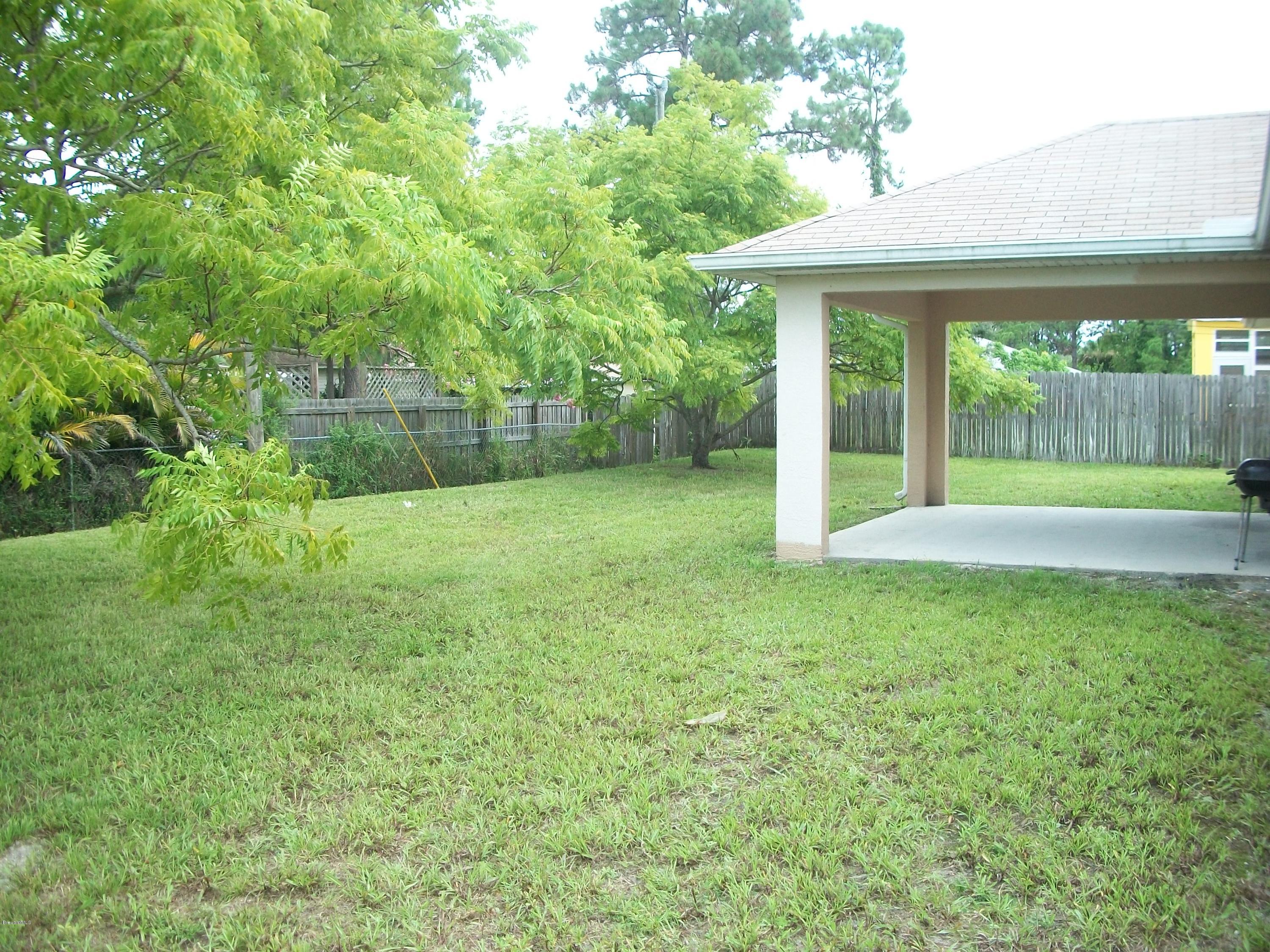 497 Australian Road Northwest Palm Bay, FL 32907 - Photo 14 of 14 Backyard w/ Covered Patio