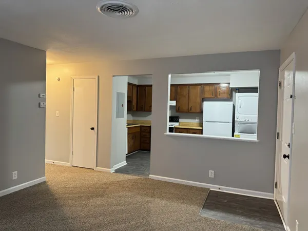 an empty room with windows and closet