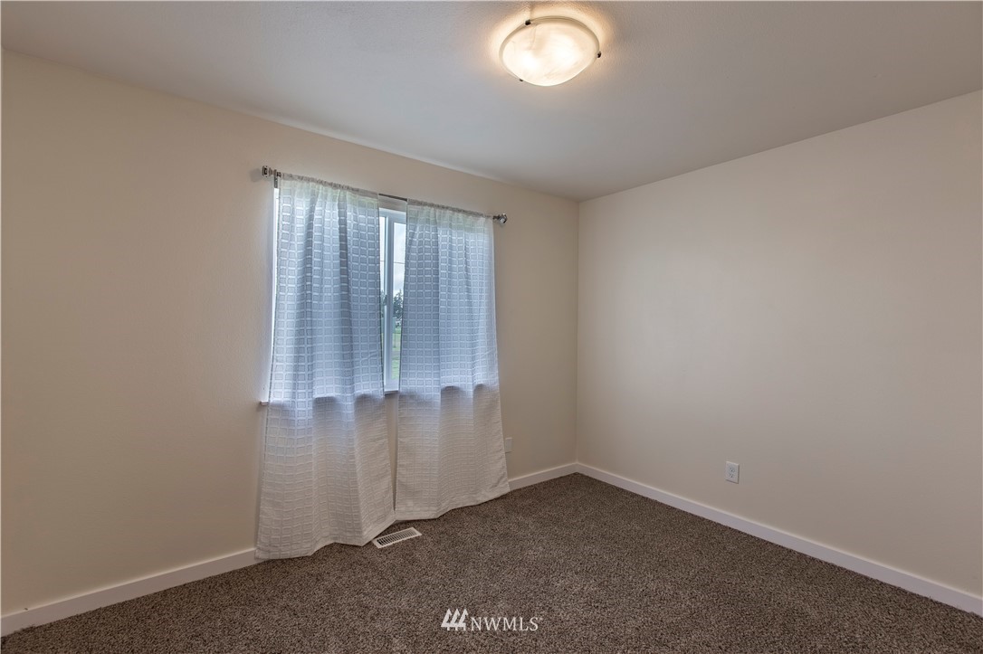 4425 180th Way Southwest Rochester, WA 98579 - Photo 12 of 25 an empty room with window