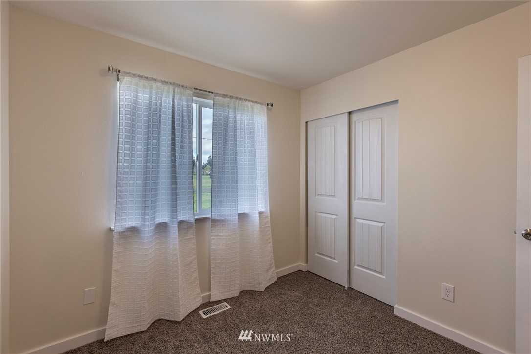 4425 180th Way Southwest Rochester, WA 98579 - Photo 15 of 25 an empty room with windows