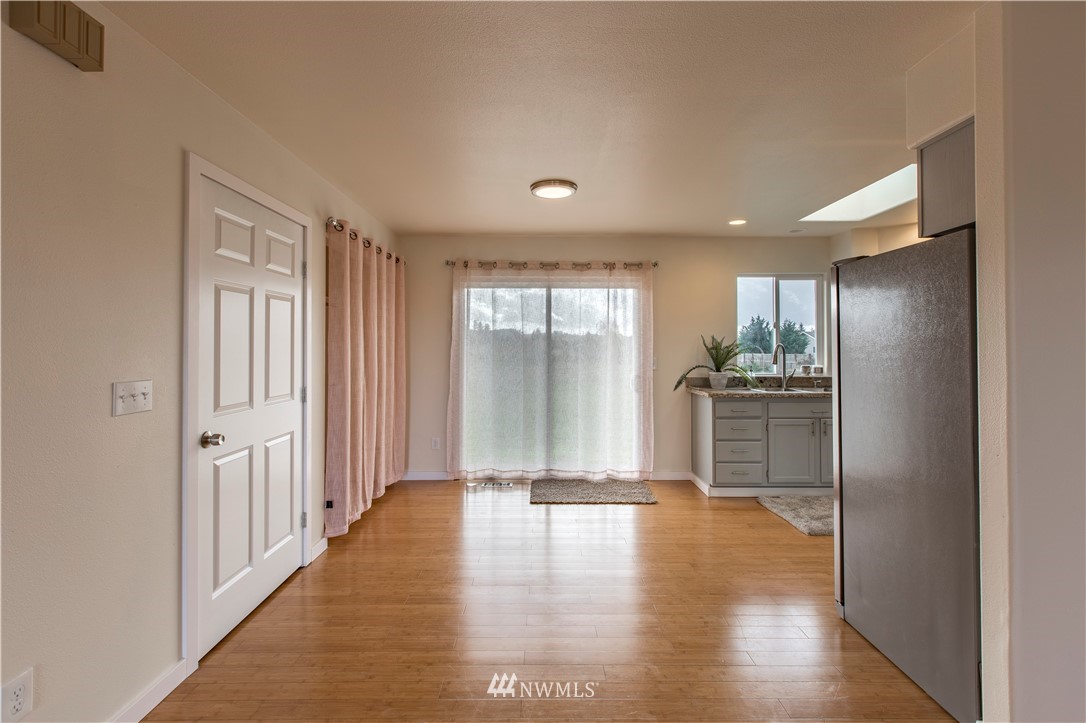 4425 180th Way Southwest Rochester, WA 98579 - Photo 16 of 25 a view of a hallway with wooden floor and a cabinet