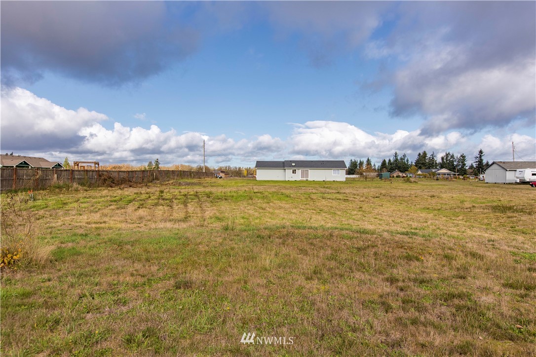 4425 180th Way Southwest Rochester, WA 98579 - Photo 18 of 25 a view of a lake with houses in the back