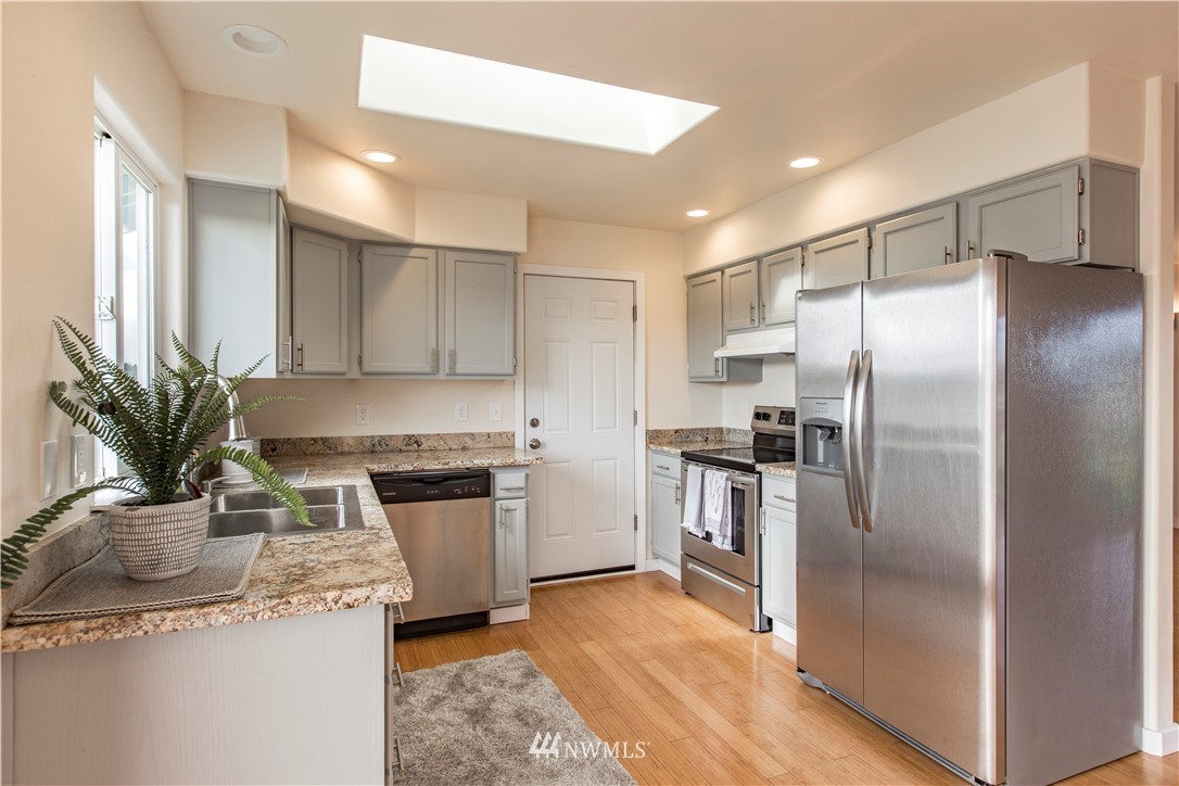 4425 180th Way Southwest Rochester, WA 98579 - Photo 20 of 25 a kitchen with stainless steel appliances granite countertop a refrigerator a stove and a sink