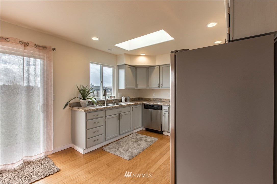 4425 180th Way Southwest Rochester, WA 98579 - Photo 21 of 25 a kitchen with a refrigerator and a sink