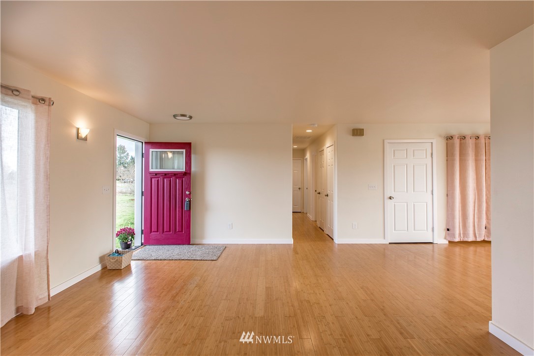 4425 180th Way Southwest Rochester, WA 98579 - Photo 6 of 25 a view of empty room with wooden floor and fan