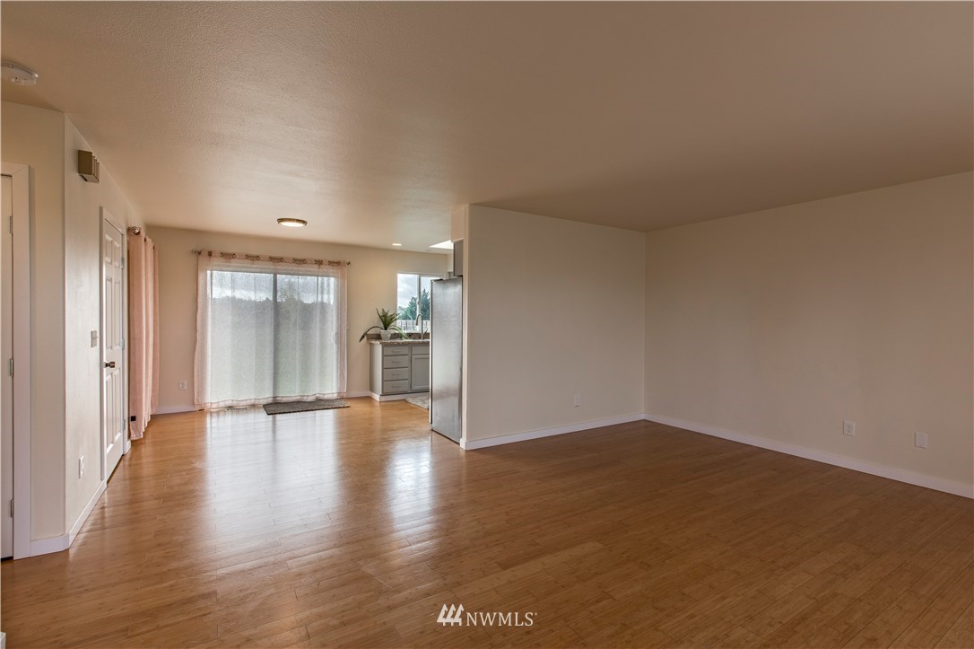 4425 180th Way Southwest Rochester, WA 98579 - Photo 7 of 25 a view of an empty room and wooden floor