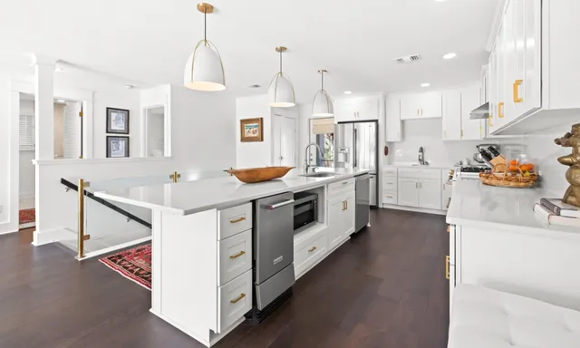 a living room with furniture a flat screen tv and a floor to ceiling window