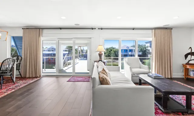 a view of a balcony with wooden floor and outdoor seating