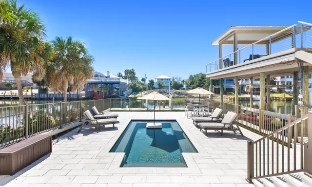 an aerial view of a house with a garden and lake view