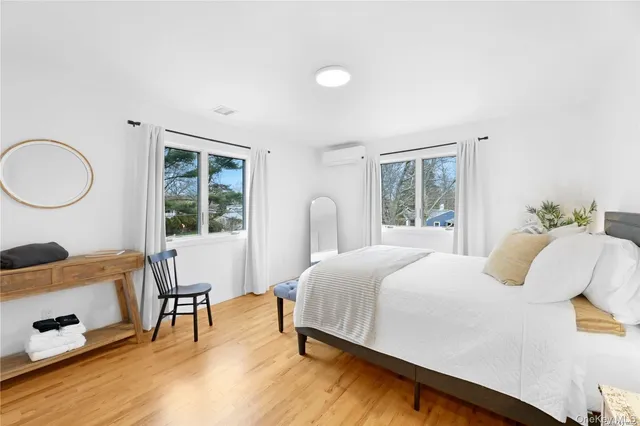 a bedroom with a bed and a large window