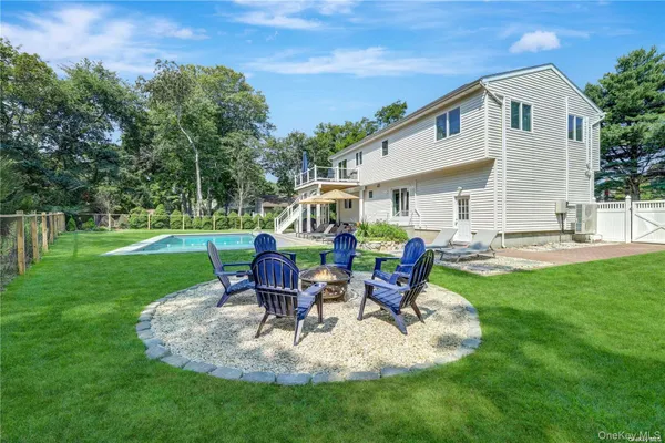 a view of a house with backyard sitting area and garden